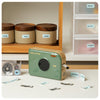 Phomemo A30 home label maker used for kitchen and drawer organization, ribbon labels applied to jars and storage boxes